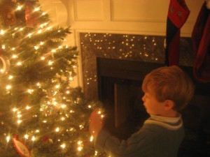 JDaniel in front of a Christmas tree.