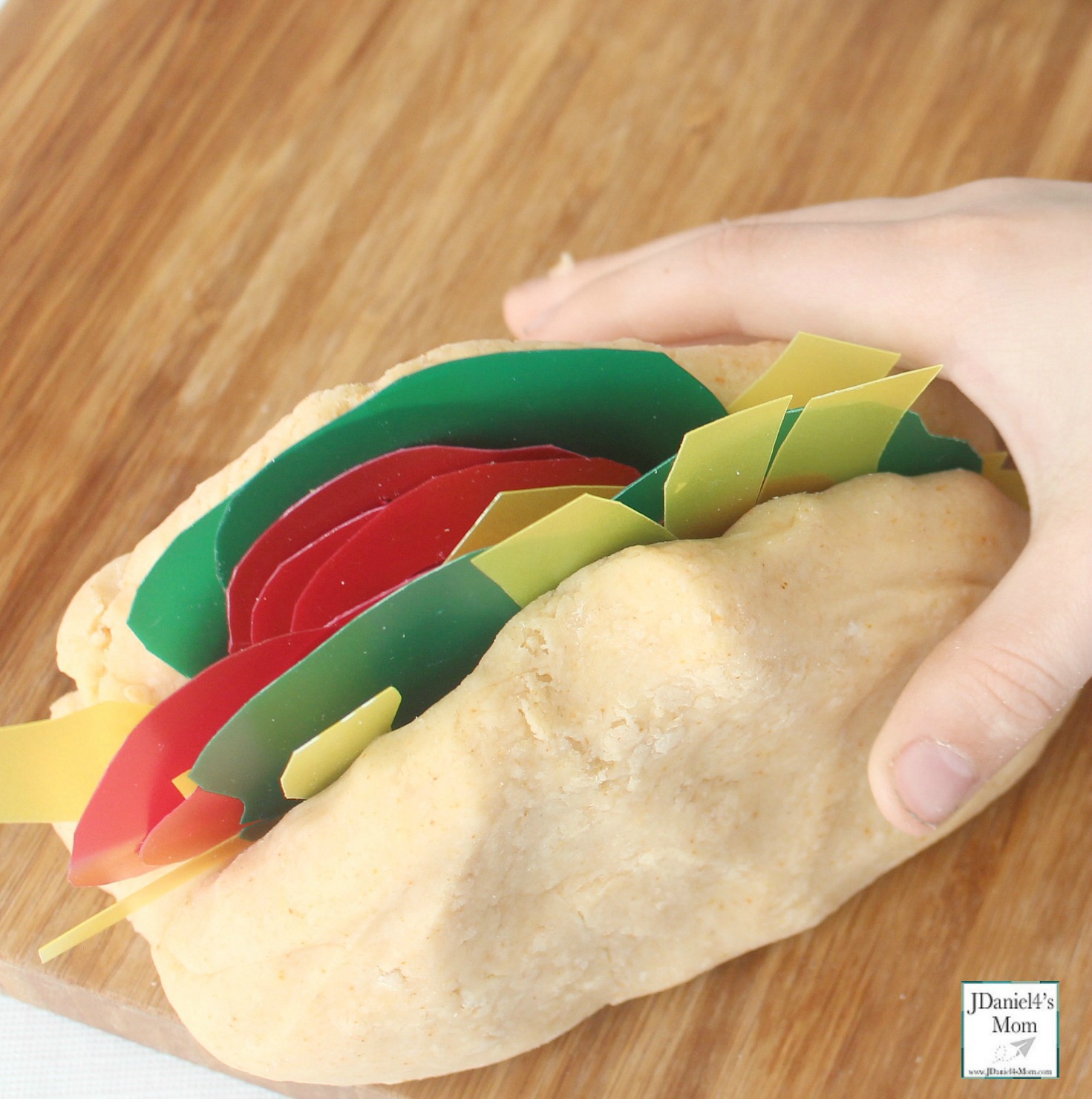 Dragons Love Tacos Themed Playdough Recipe and Activity - Children at home and students at school will have fun building dinosaurs sized tacos with taco scented playdough. This playdough recipe is so easy to make. This is what a filled taco looks like.