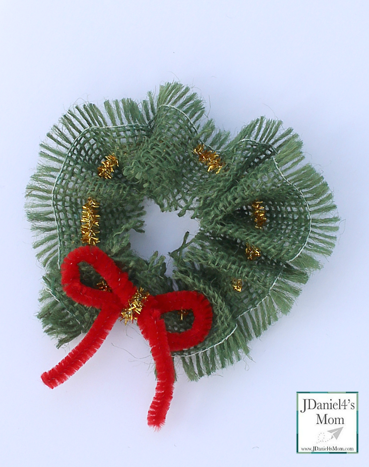 Fine Motor Skills: Christmas DIY Wreath Ornament- Kids can easily thread a pipe cleaner through burlap to create this Christmas Ornament.