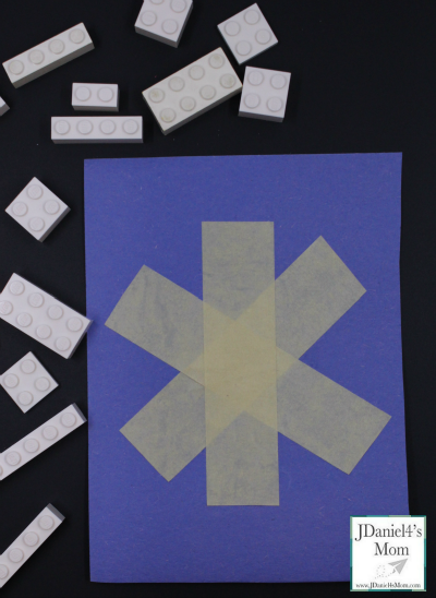 Building LEGO snowflake patterns on a simple snowflake outline gives kids the opportunity to explore symmetry.