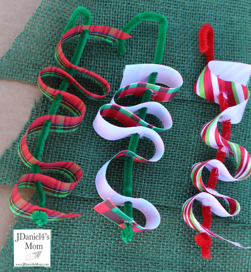 Ribbon Candy Homemade Ornament- Fun fine motor craft for kids. They will have fun weaving pretty holiday ribbons through pipe cleaners.