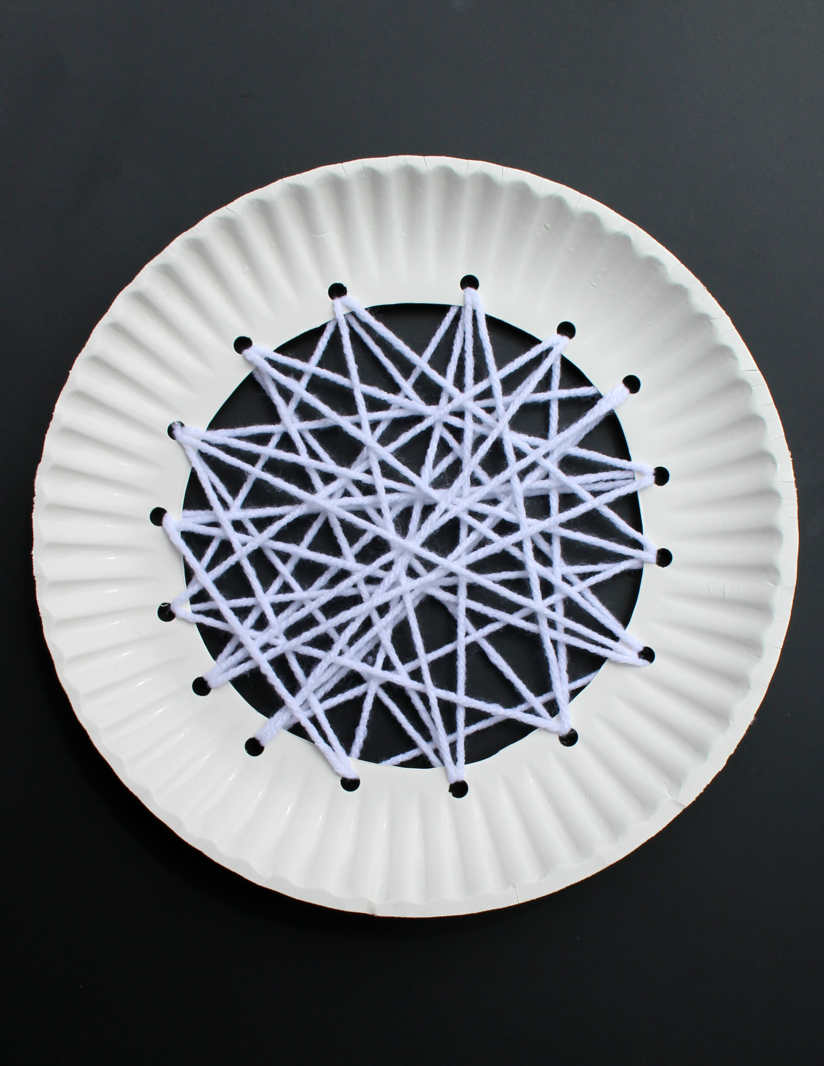 Apple Craft That Works on Fine Motor Skills - White Yarn Weaving in the Middle of the Plate