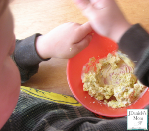 Mixing the ingredients in the deviled egg recipe for kids.