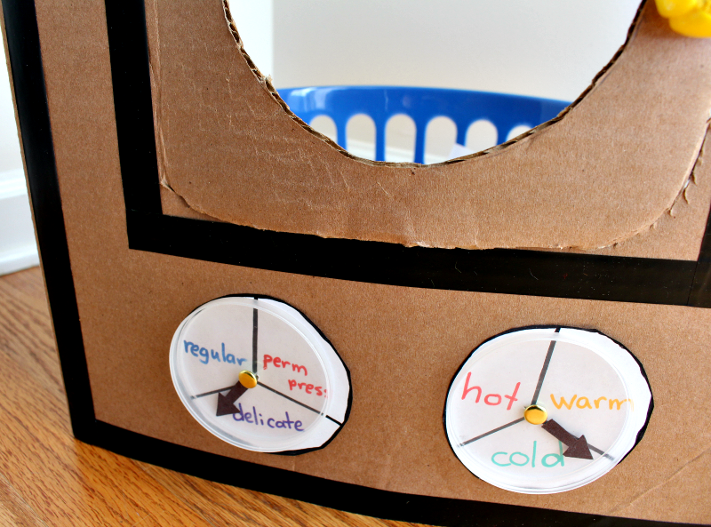 A DIY Cardboard Kids' Washing Machine - It is great for pretend play or a part of a learning activity for kids. It has movable dials.