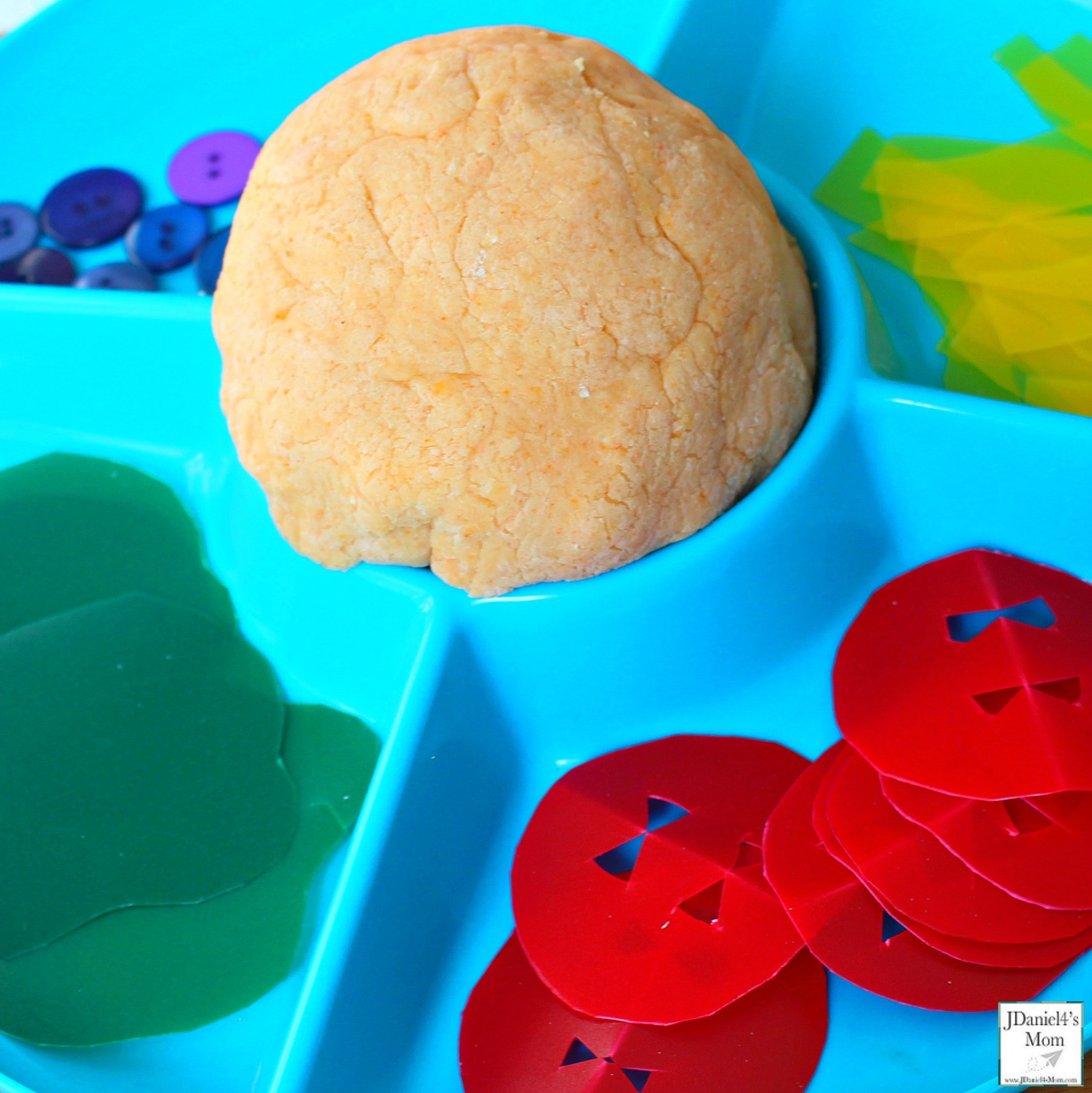 Dragons Love Tacos Themed Playdough Recipe and Activity - Children at home and students at school will have fun building dinosaurs sized tacos with taco scented playdough. This playdough recipe is so easy to make. This what the activity supplies look like in a tray.