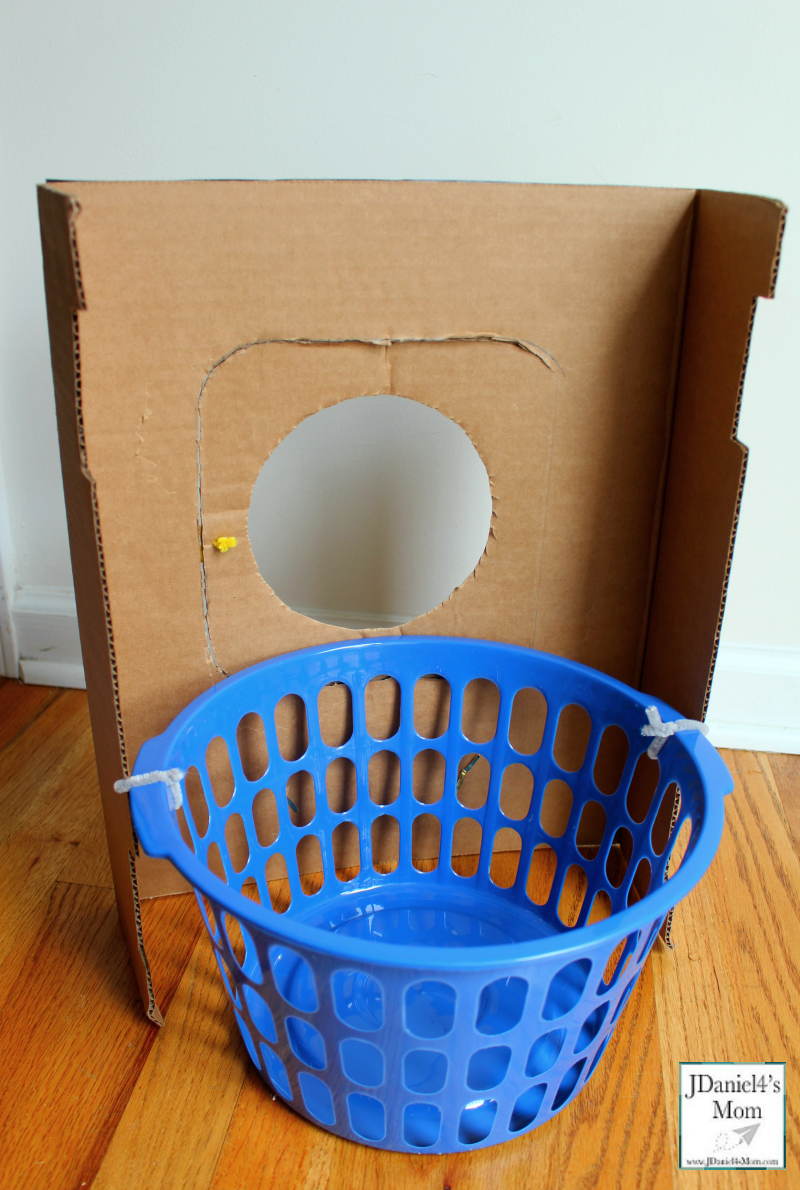 A DIY Cardboard Kids' Washing Machine - It is great for pretend play or a part of a learning activity for kids. It has a removable laundry basket. It is great for holding the object placed in the washing machine.